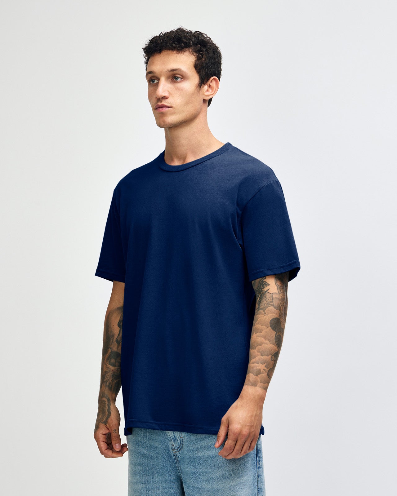 Male model wearing sueded white colour  Unisex Short Sleeve Crew Neck Tee (front pose) -navy