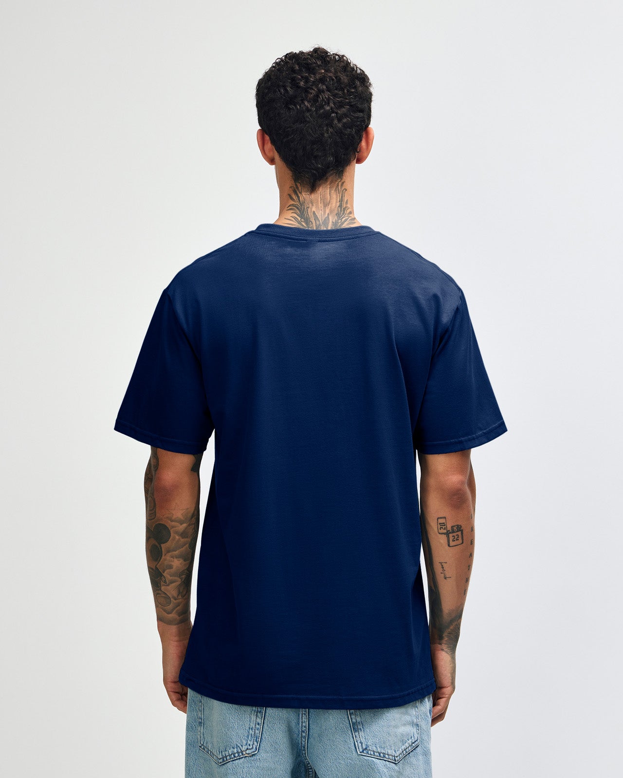 Male model wearing sueded white colour  Unisex Short Sleeve Crew Neck Tee (front pose) -navy