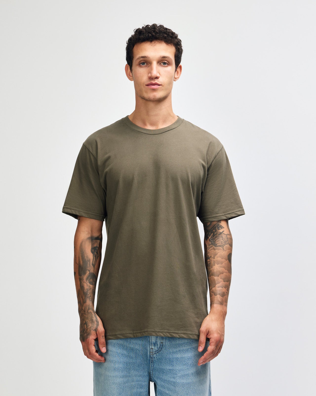 Male model wearing sueded white colour  Unisex Short Sleeve Crew Neck Tee (front pose) -lieutenant