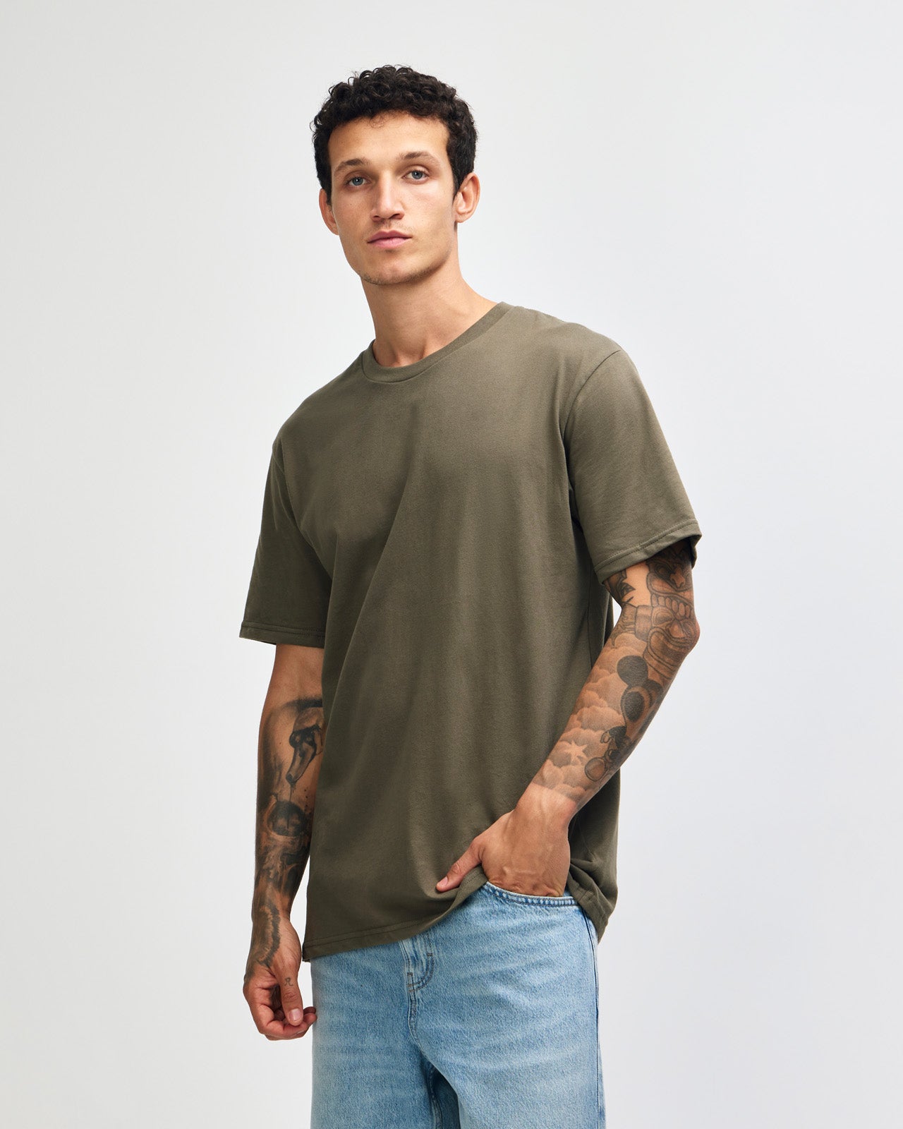 Male model wearing sueded white colour  Unisex Short Sleeve Crew Neck Tee (front pose) -lieutenant