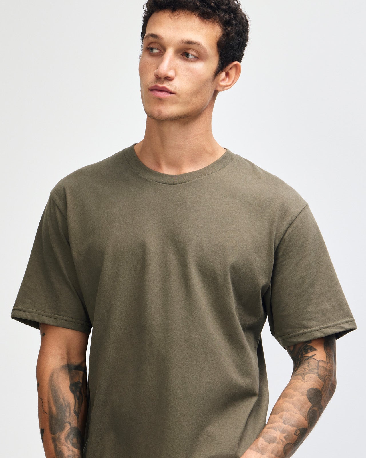 Male model wearing sueded white colour  Unisex Short Sleeve Crew Neck Tee (front pose) -lieutenant