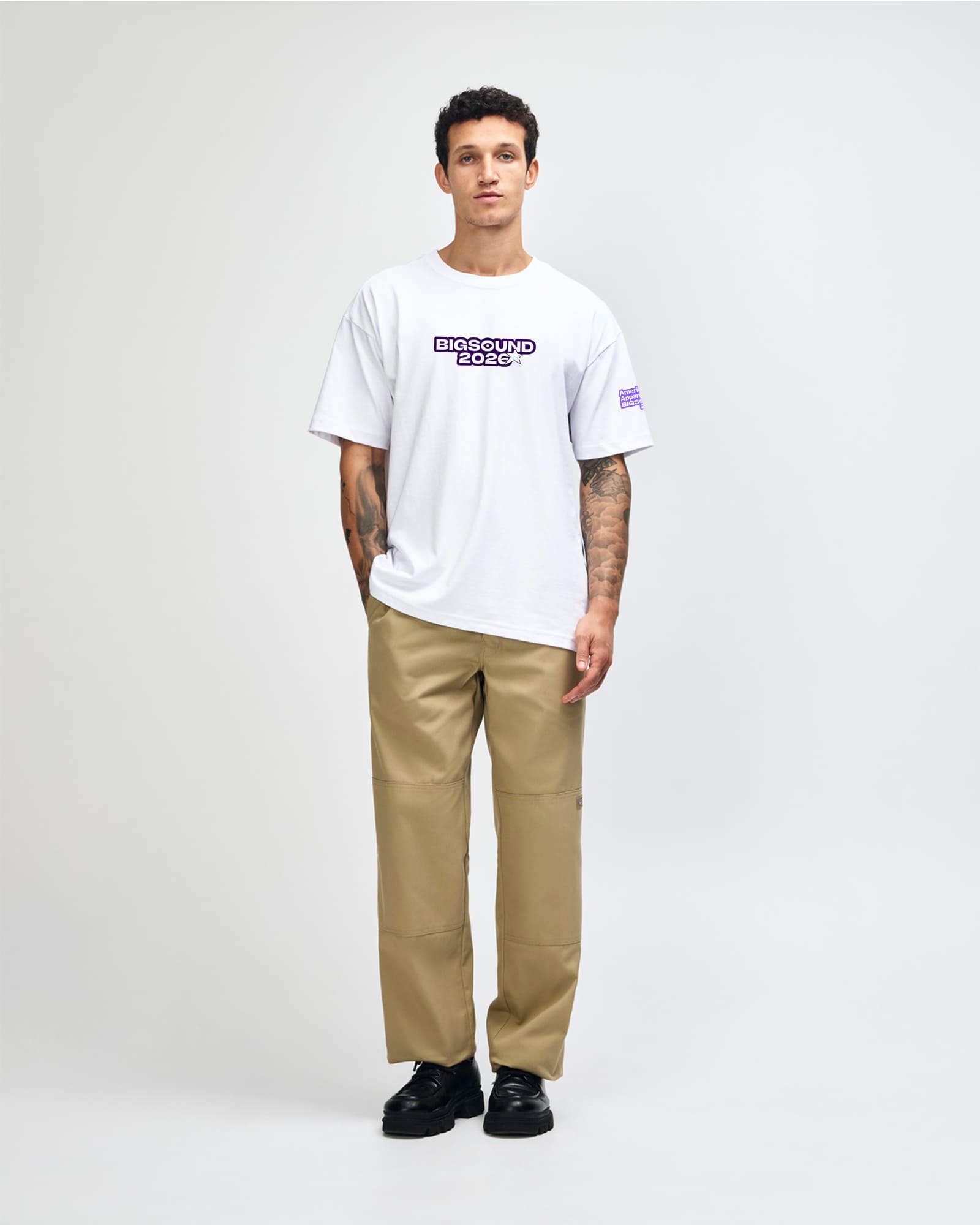 Man wearing a white t shirt and beige pants on a white background-white