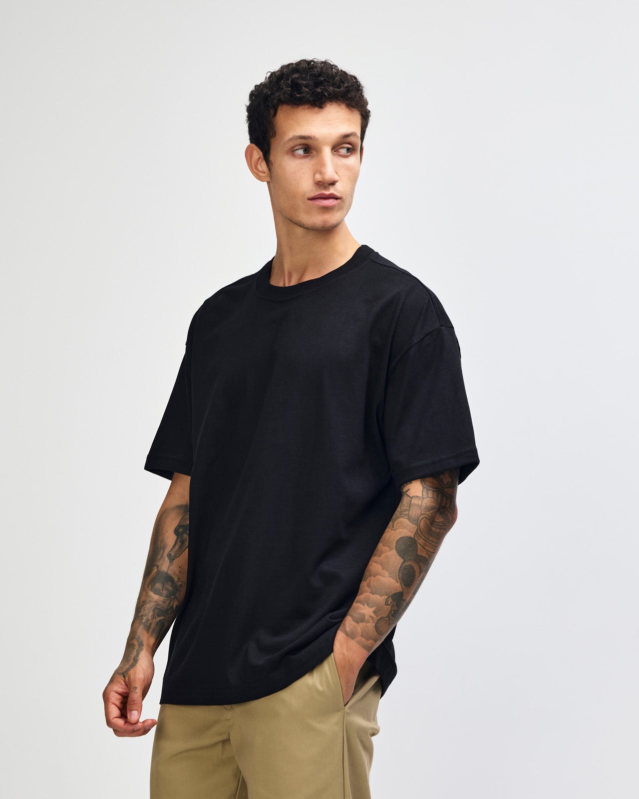 Male model wearing an American Apparel 9001 Unisex Oversized Fit Super Heavyweight T-shirt - black