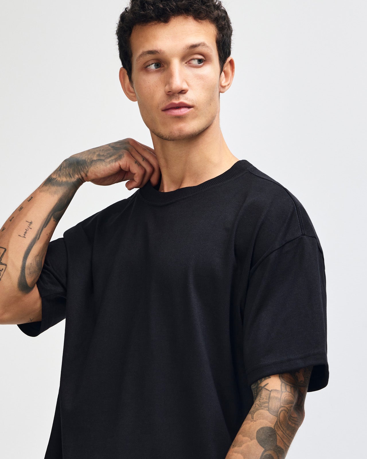 Male model wearing an American Apparel 9001 Unisex Oversized Fit Super Heavyweight T-shirt - black