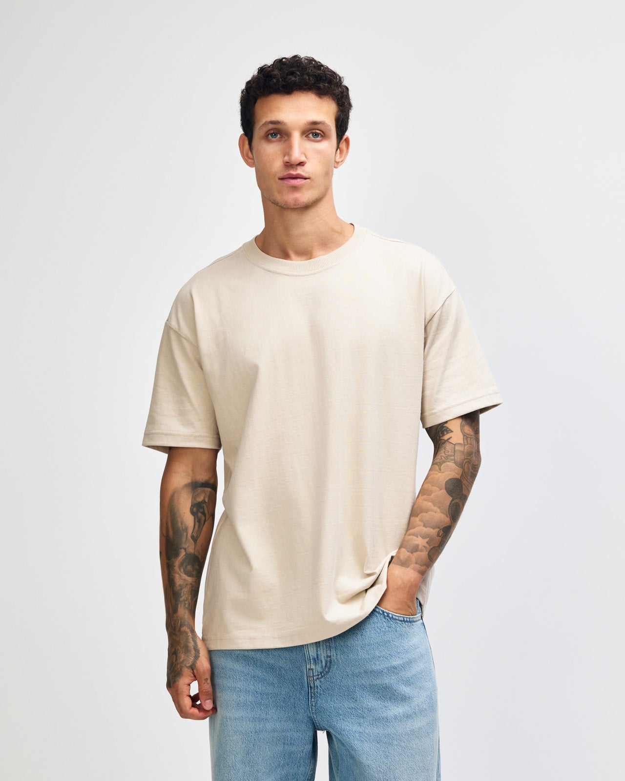 Male model wearing an American Apparel 9001 Unisex Oversized Fit Super Heavyweight T-shirt - bone