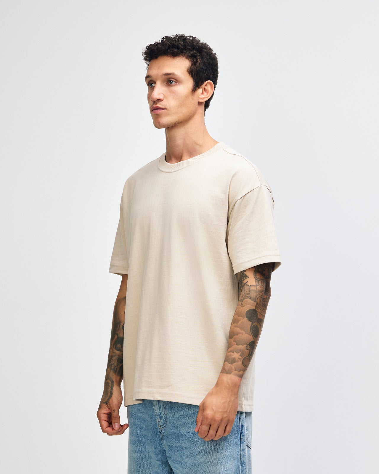 Male model wearing an American Apparel 9001 Unisex Oversized Fit Super Heavyweight T-shirt - bone