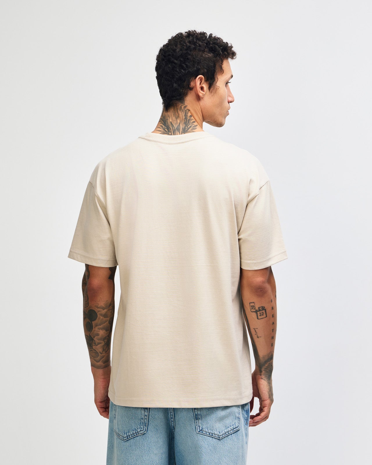 Male model wearing an American Apparel 9001 Unisex Oversized Fit Super Heavyweight T-shirt - bone