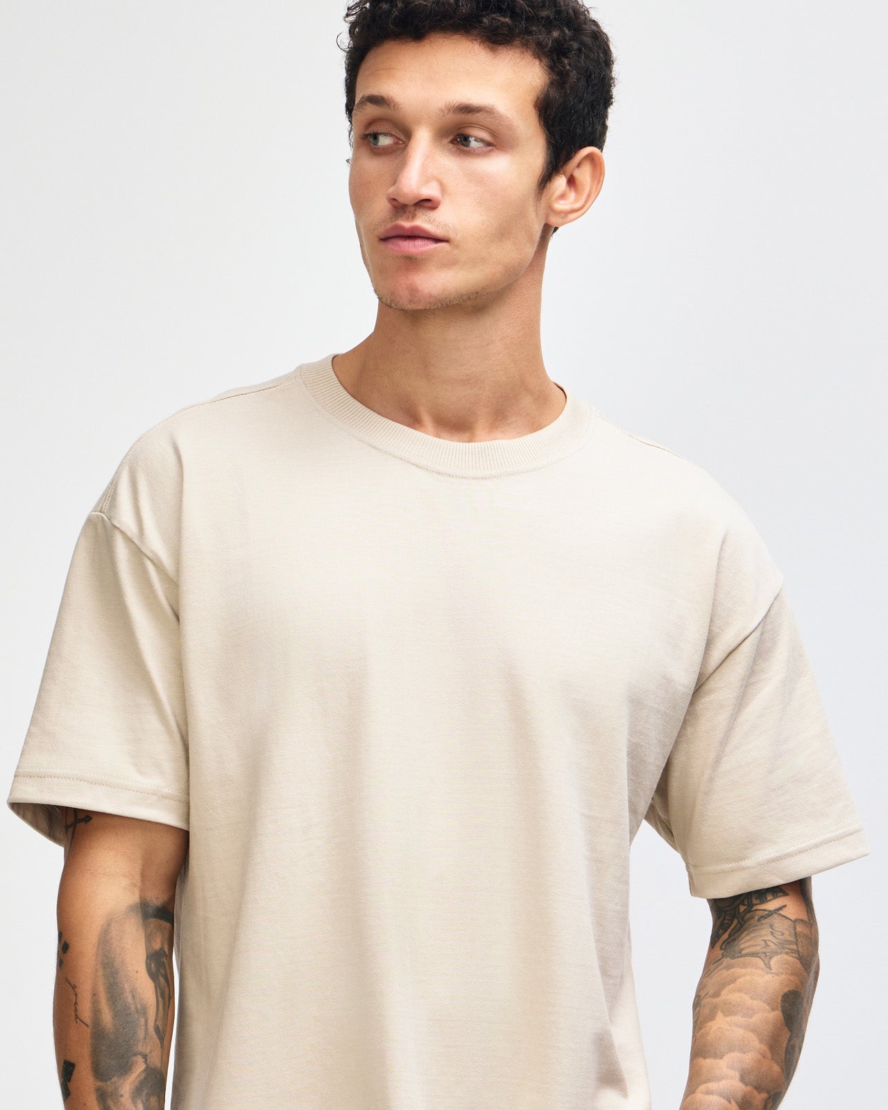 Male model wearing an American Apparel 9001 Unisex Oversized Fit Super Heavyweight T-shirt - bone