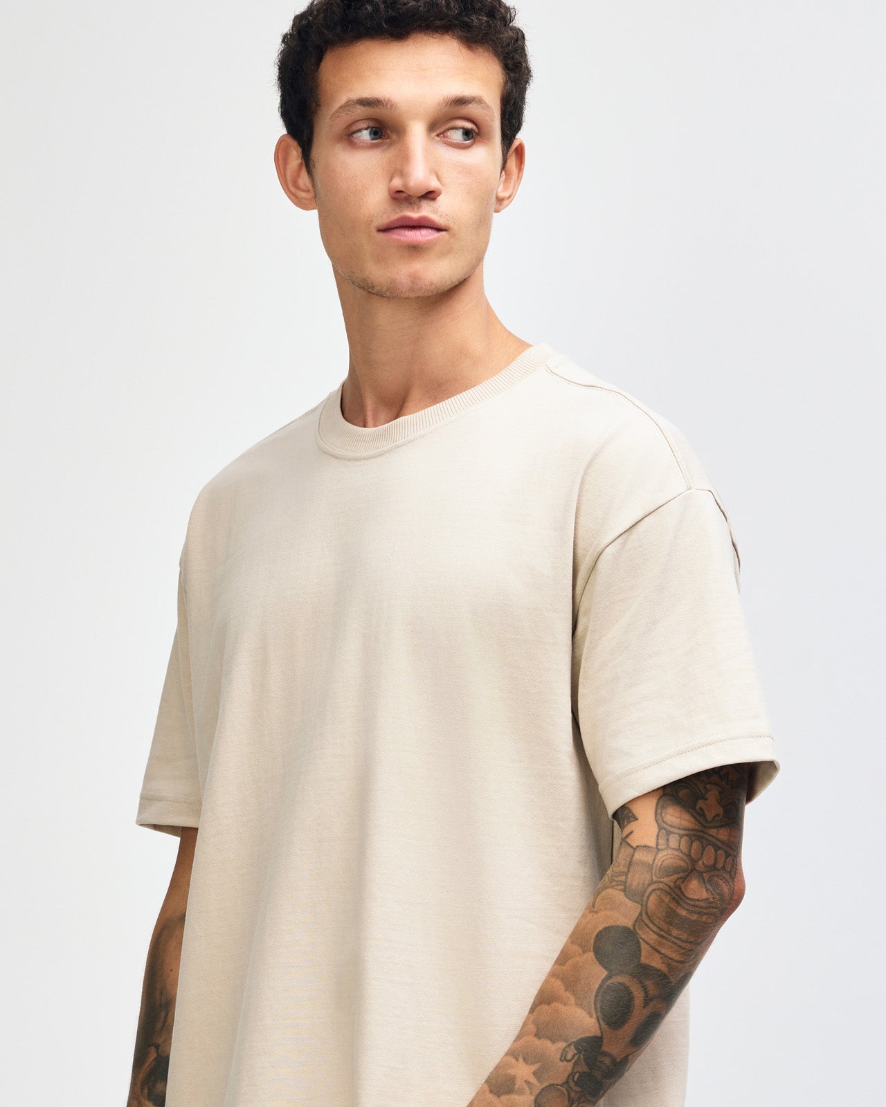 Male model wearing an American Apparel 9001 Unisex Oversized Fit Super Heavyweight T-shirt - bone