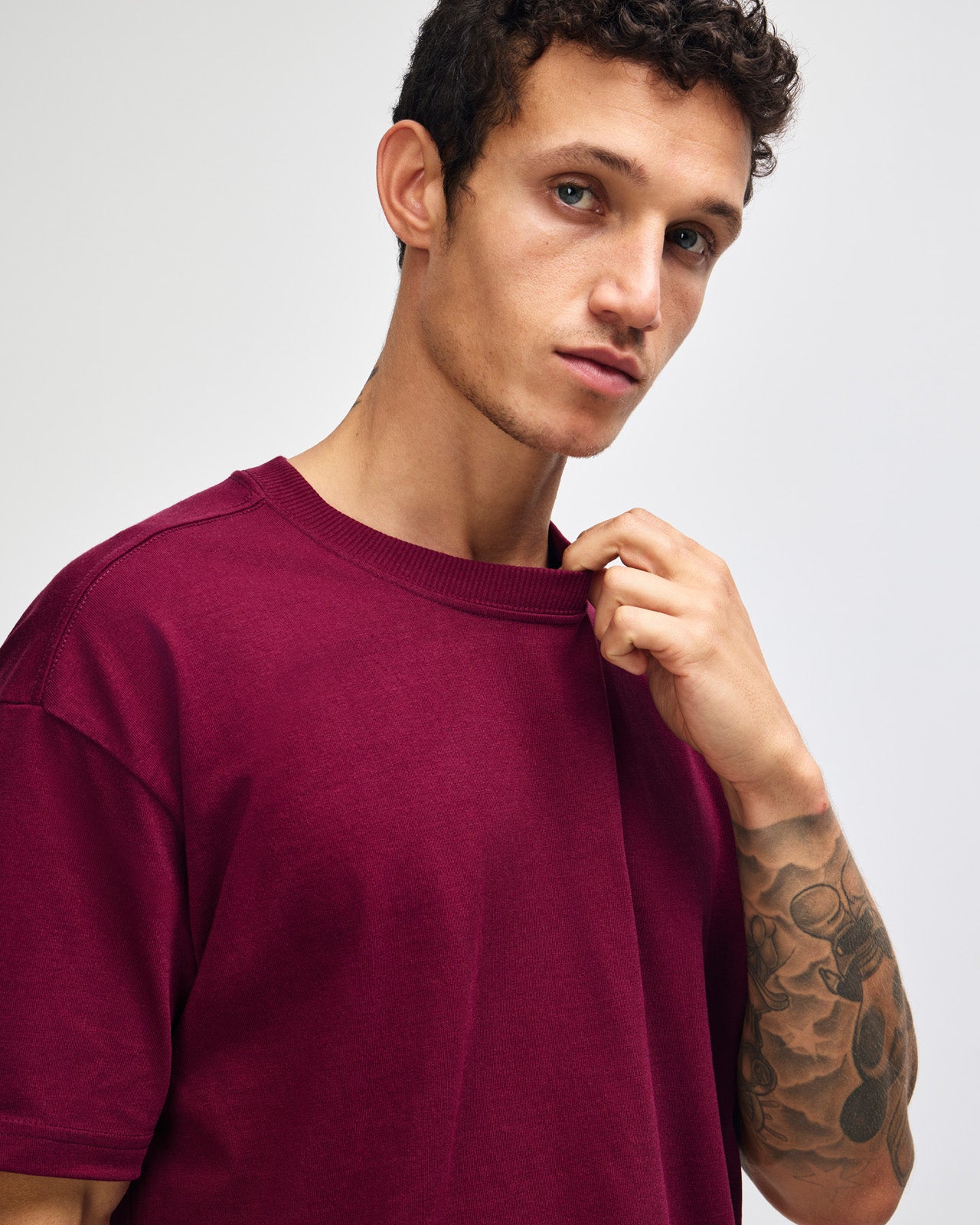 Male model wearing an American Apparel 9001 Unisex Oversized Fit Super Heavyweight T-shirt - burgundy