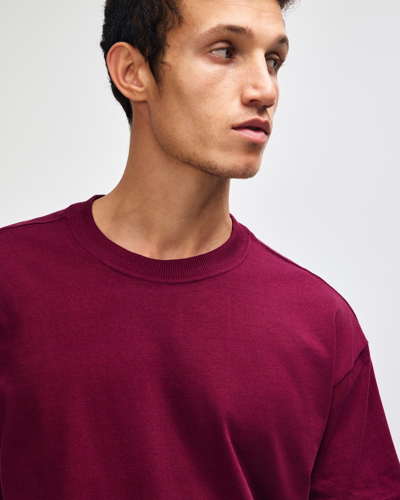 Male model wearing an American Apparel 9001 Unisex Oversized Fit Super Heavyweight T-shirt - burgundy