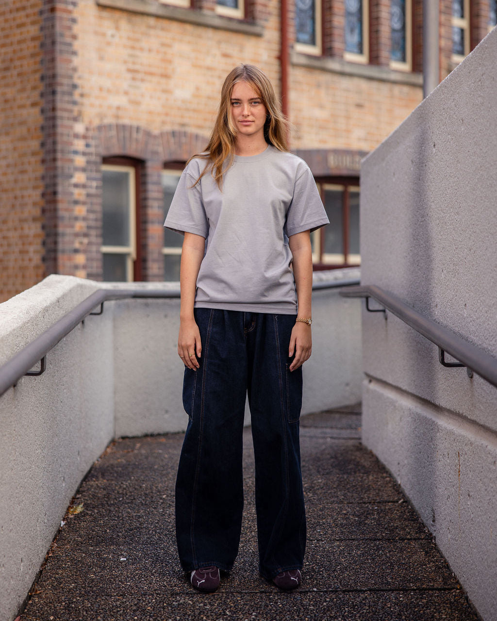 Female model wearing an American Apparel 9001 Unisex Oversized Fit Super Heavyweight T-shirt - Gravel
