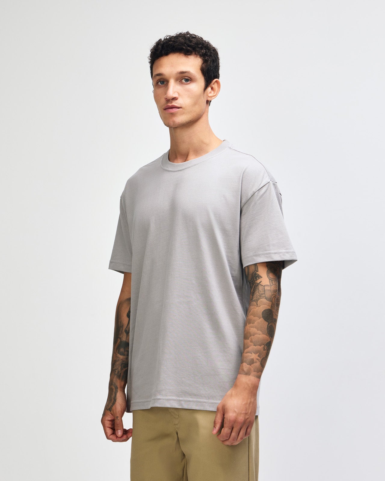 Male model wearing an American Apparel 9001 Unisex Oversized Fit Super Heavyweight T-shirt - Gravel