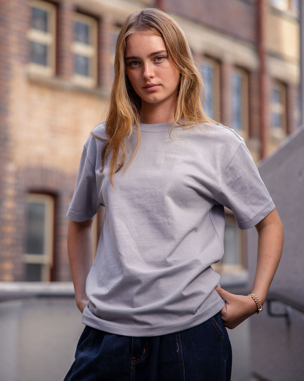 Female model wearing an American Apparel 9001 Unisex Oversized Fit Super Heavyweight T-shirt - Gravel