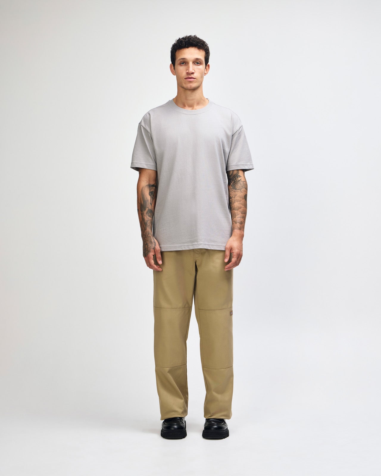 Male model wearing an American Apparel 9001 Unisex Oversized Fit Super Heavyweight T-shirt - Gravel