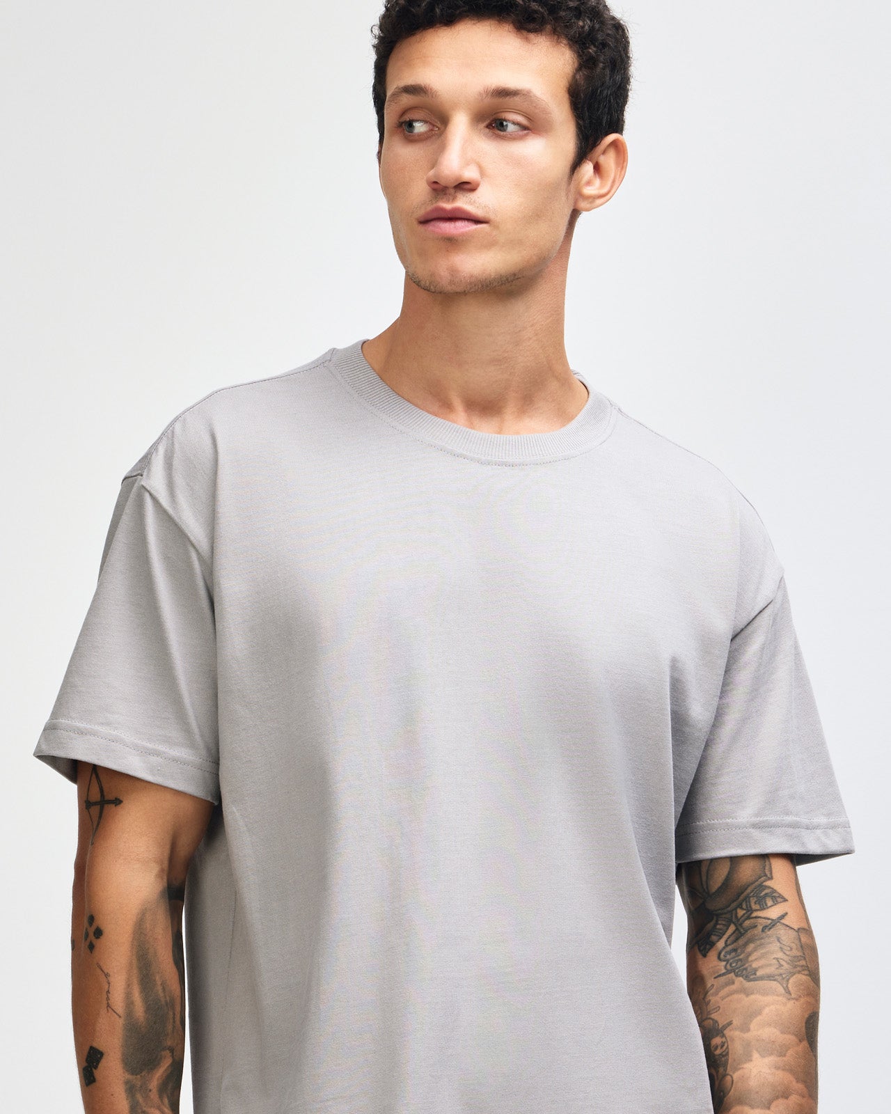 Male model wearing an American Apparel 9001 Unisex Oversized Fit Super Heavyweight T-shirt - Gravel