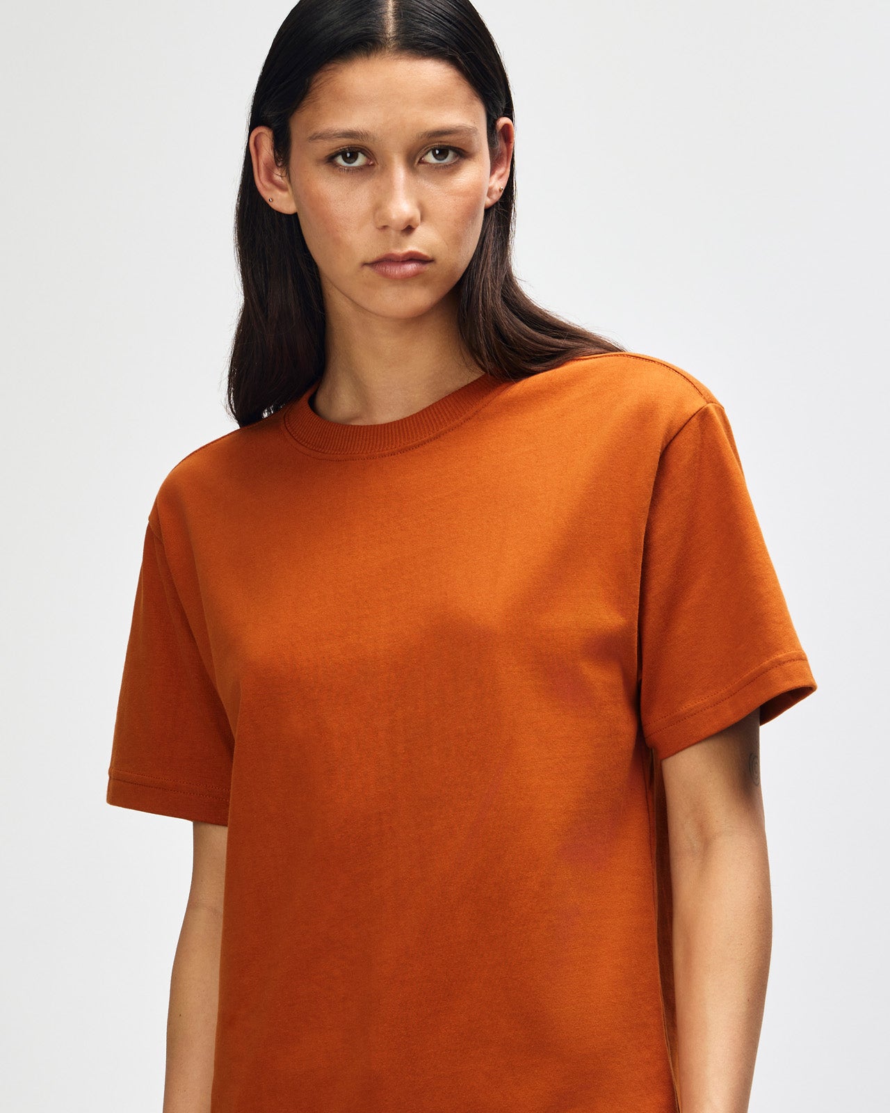 Female model wearing an American Apparel 9001 Unisex Oversized Fit Super Heavyweight T-shirt - Rust