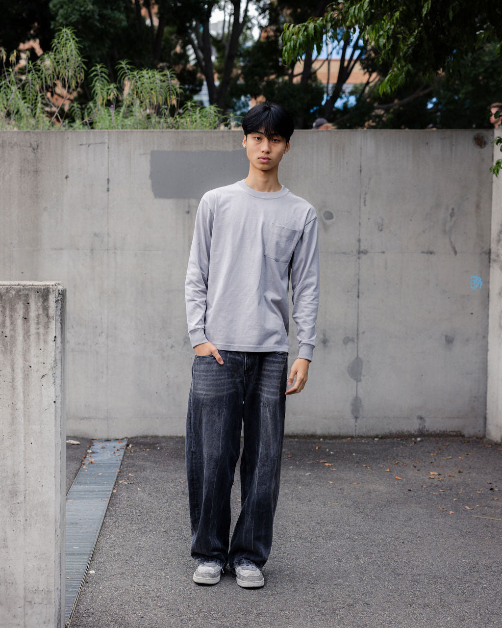 Male model wearing an American Apparel 9410 Unisex Oversized Fit Super Heavyweight Long Sleeve T-shirt - Gravel