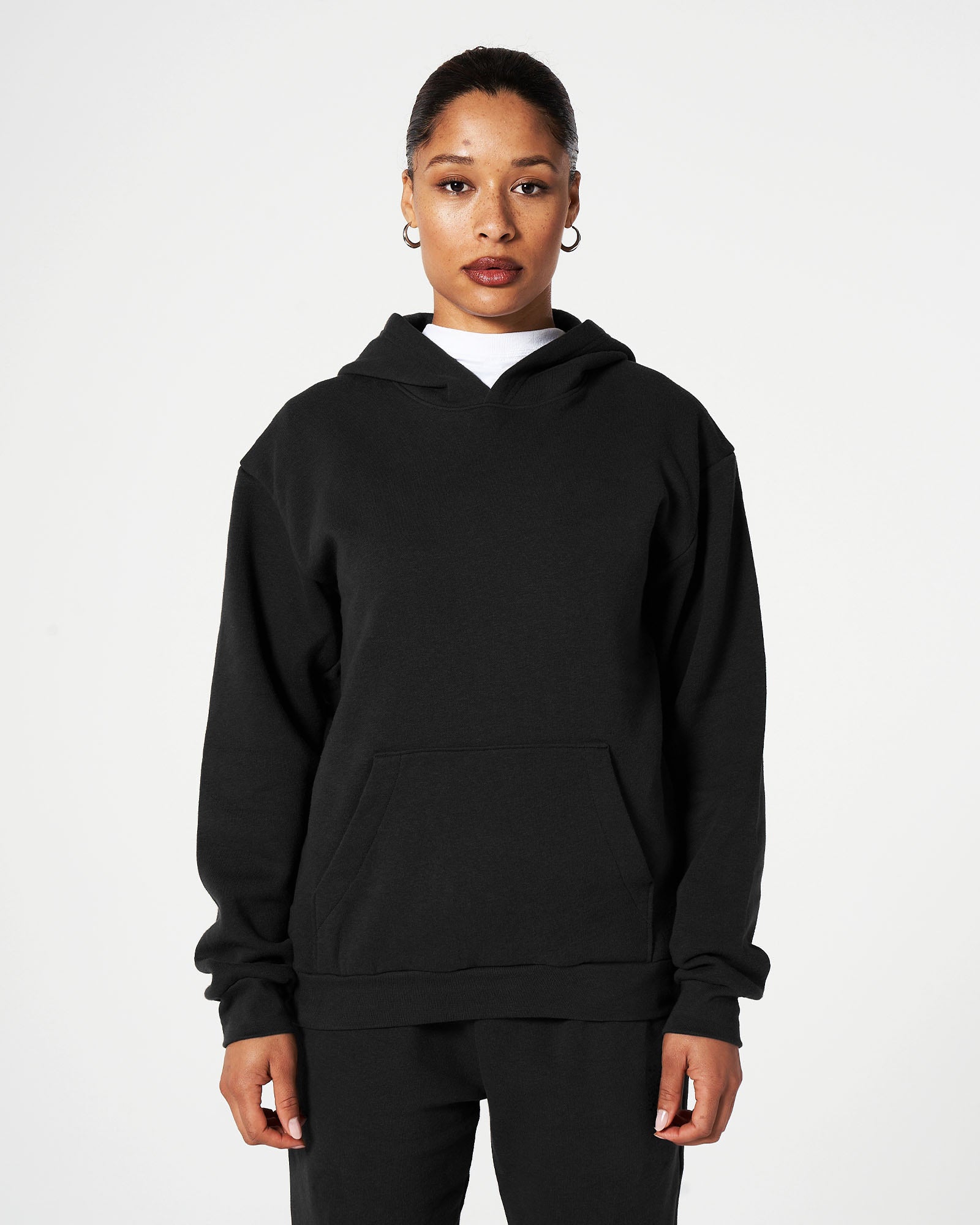 Female model wearing American Apparel Black Sweatpants & Hoodie Tracksuit Set (front pose) -black