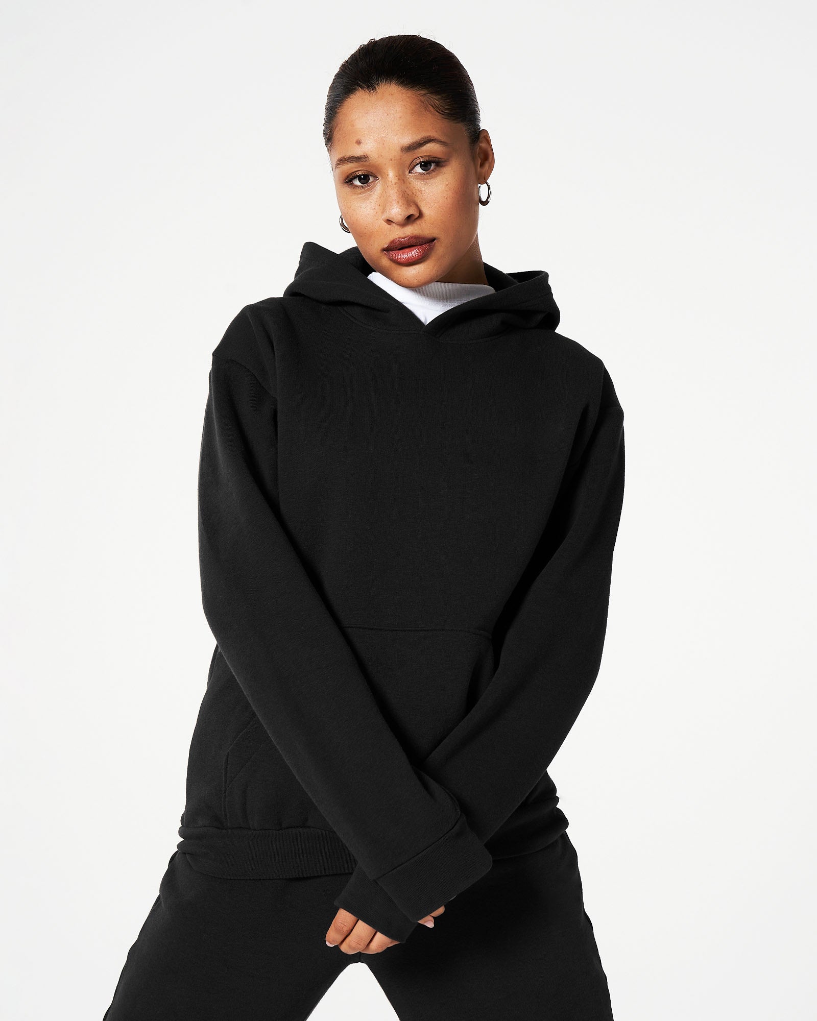 Female model wearing American Apparel Black Sweatpants & Hoodie Tracksuit Set (front pose) -black