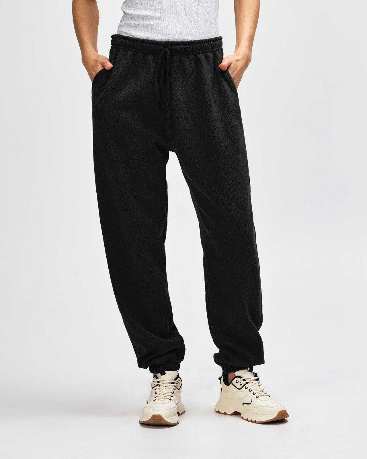 Female model wearing American Apparel Sweatpants (front pose) -black