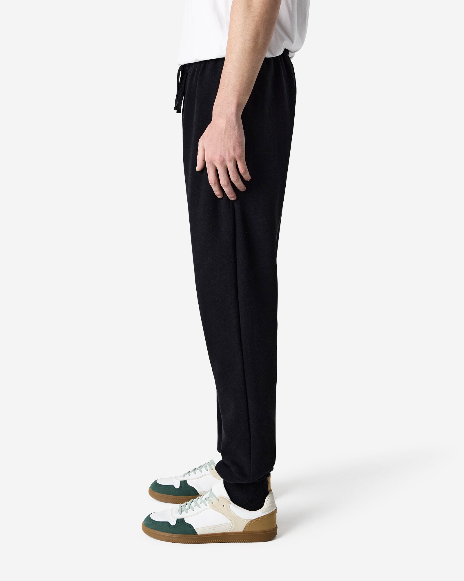 Male model wearing American Apparel Black Sweatpants (front pose) -black