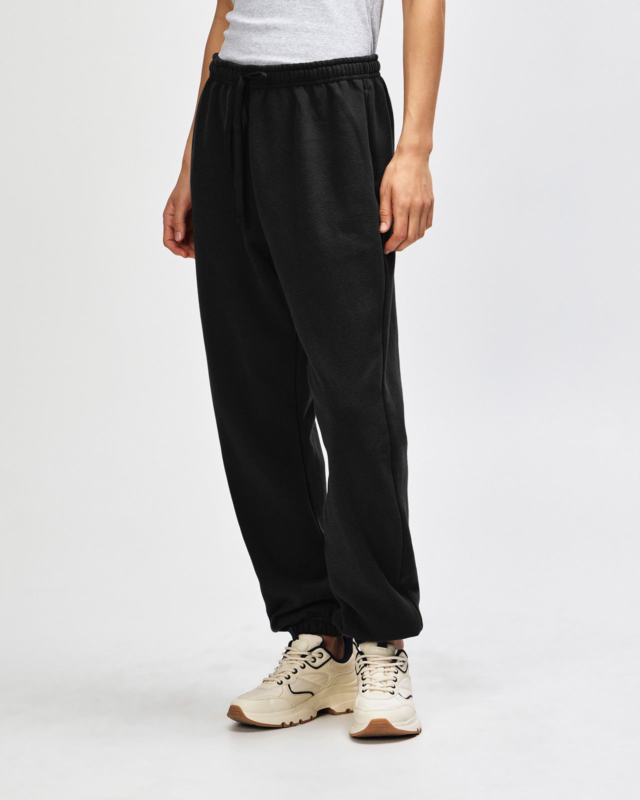 Female model wearing American Apparel Sweatpants (front pose) -black