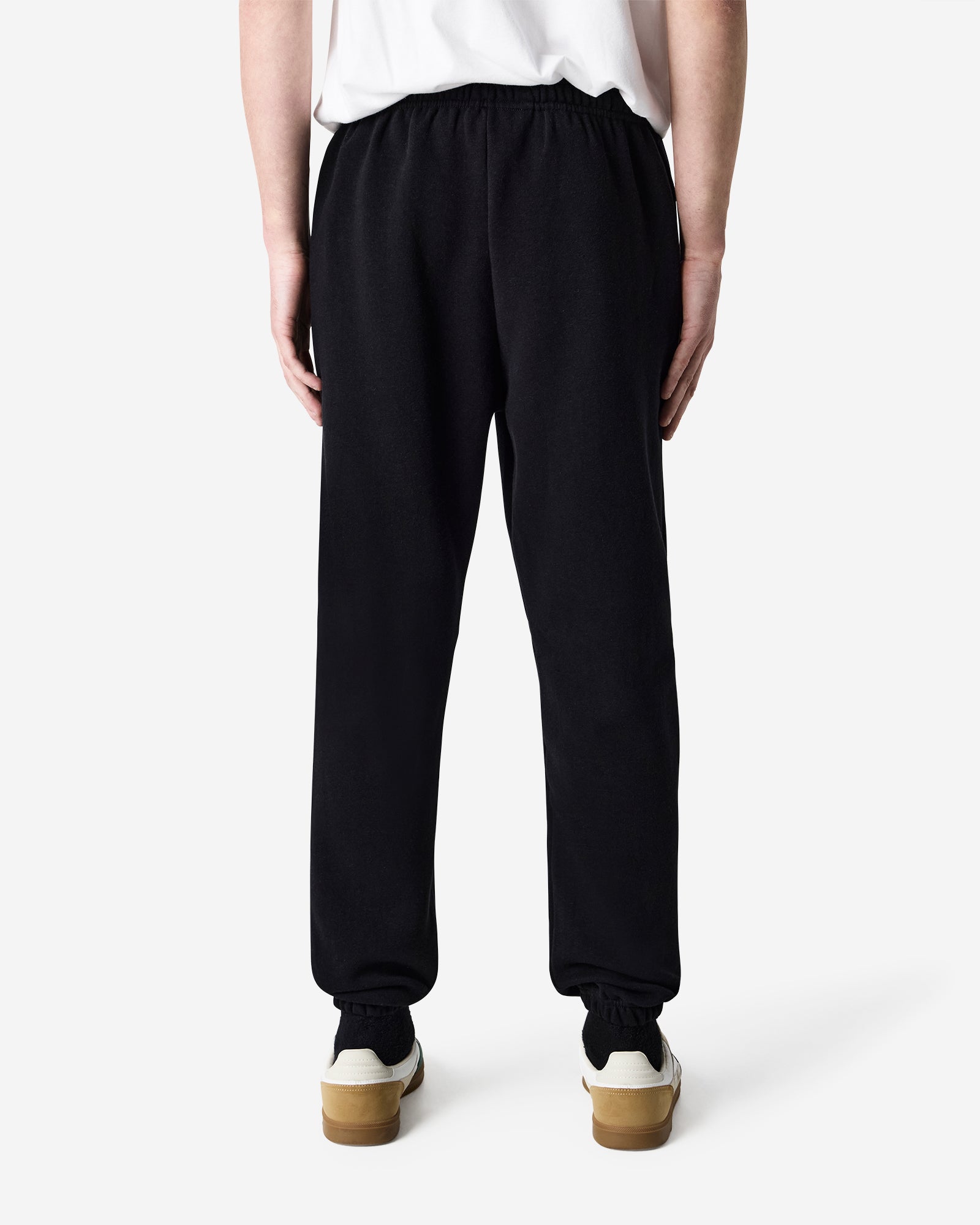 Male model wearing American Apparel Black Sweatpants (back pose) -black