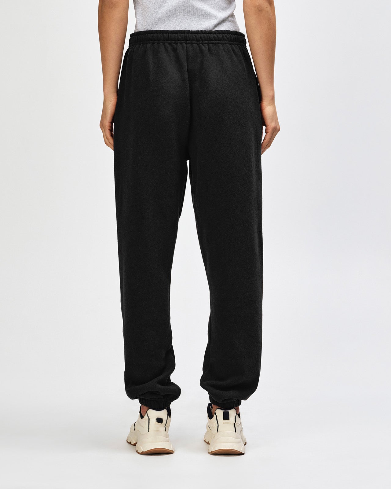 Person wearing black sweatpants on a white background -black