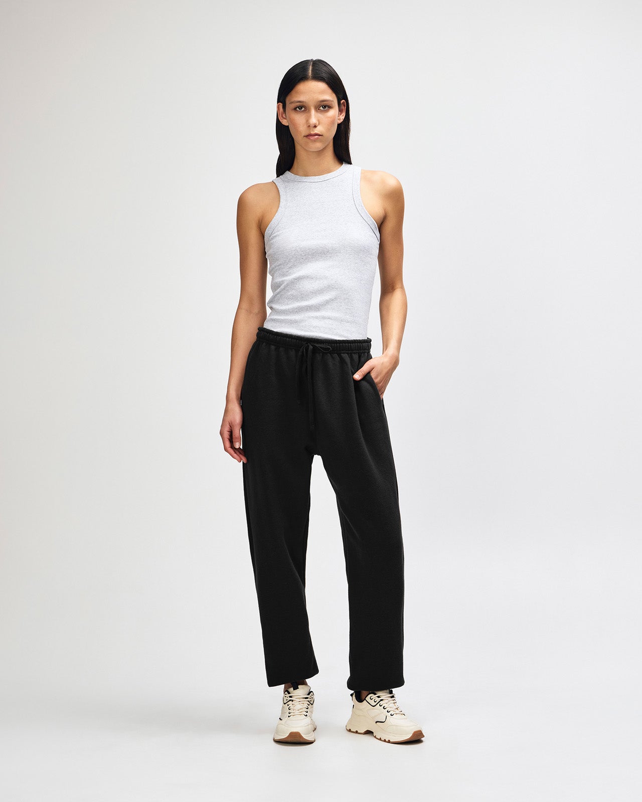 Female model wearing American Apparel Sweatpants (front pose) -black