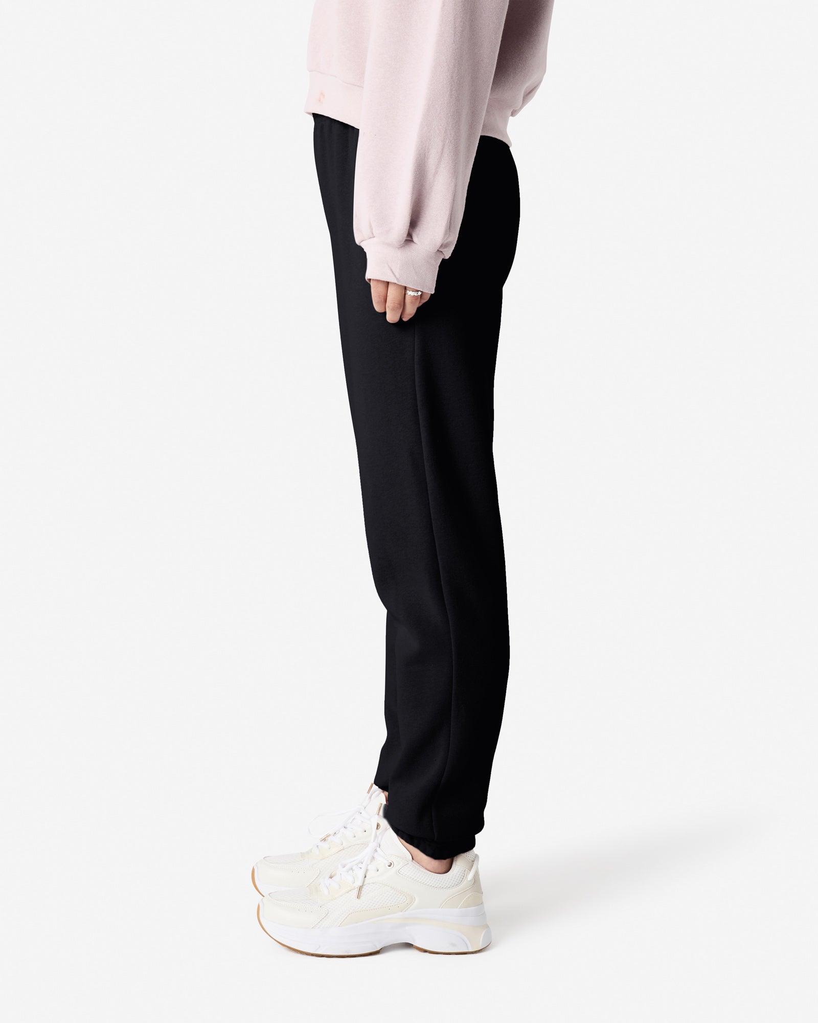 Female model wearing American Apparel Black Sweatpants (side pose) -black