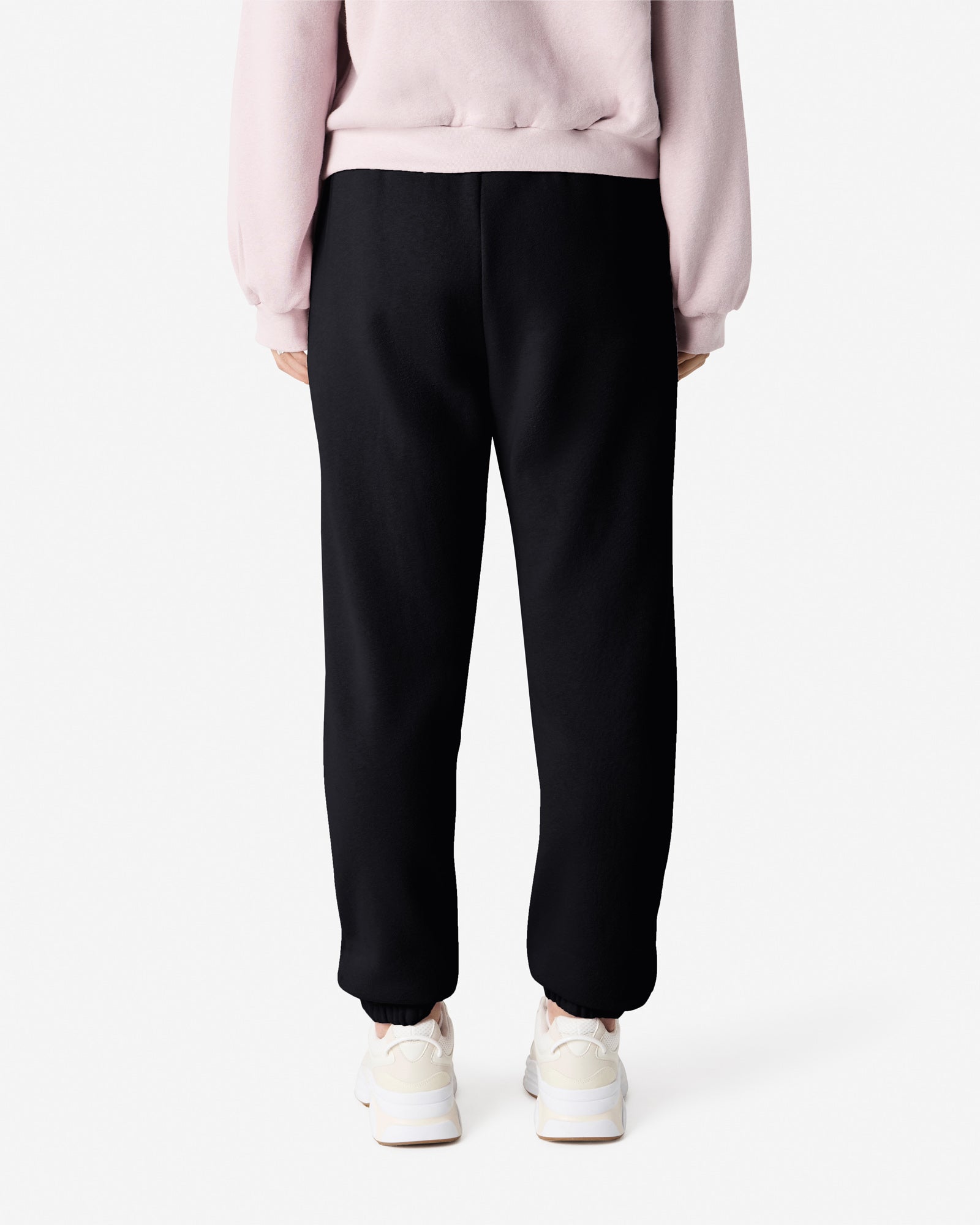 Female model wearing American Apparel Black Sweatpants (back pose) -black