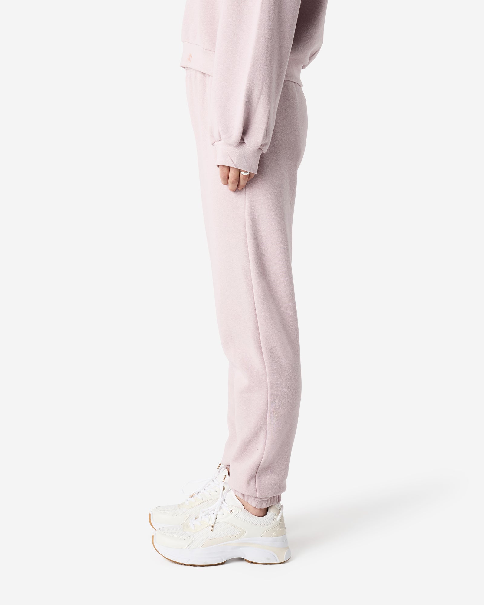 Female model wearing American Apparel Blush Sweatpants (side pose) -blush