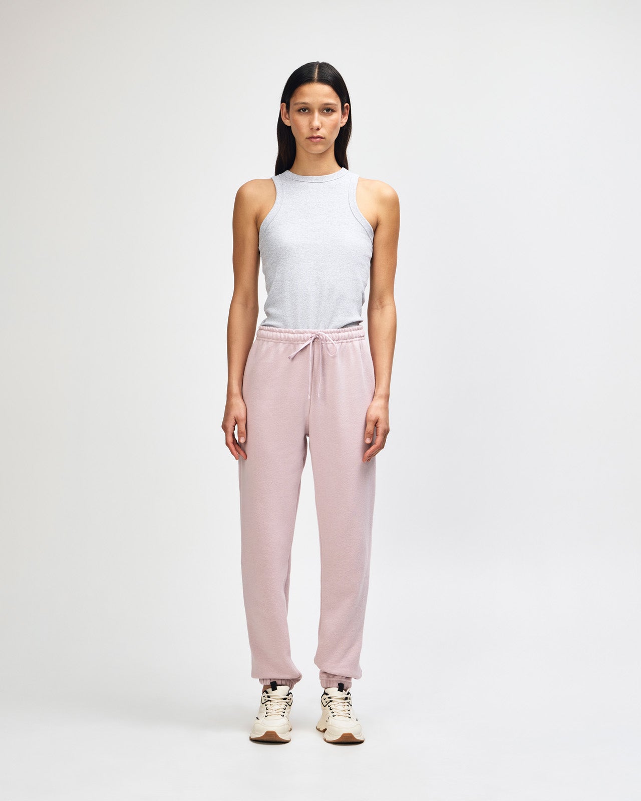 Female model wearing Reflex Unisex Sweatpants (full view pose) -blush