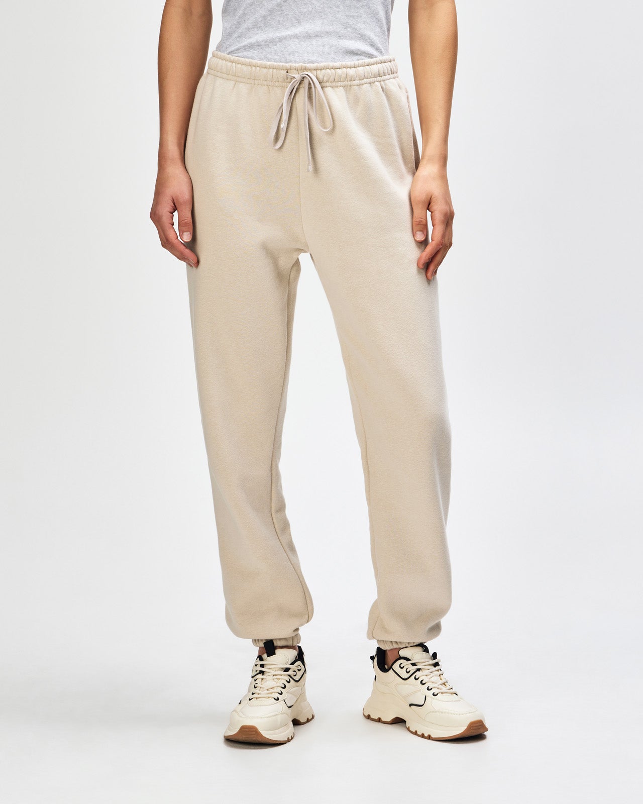 Female model wearing American Apparel Sweatpants (front pose) -bone