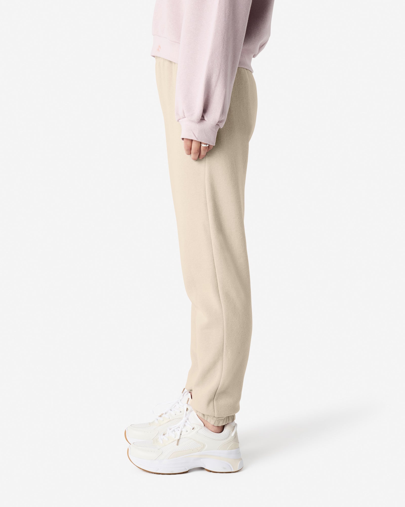 Female model wearing American Apparel Bone Sweatpants (side pose) -bone