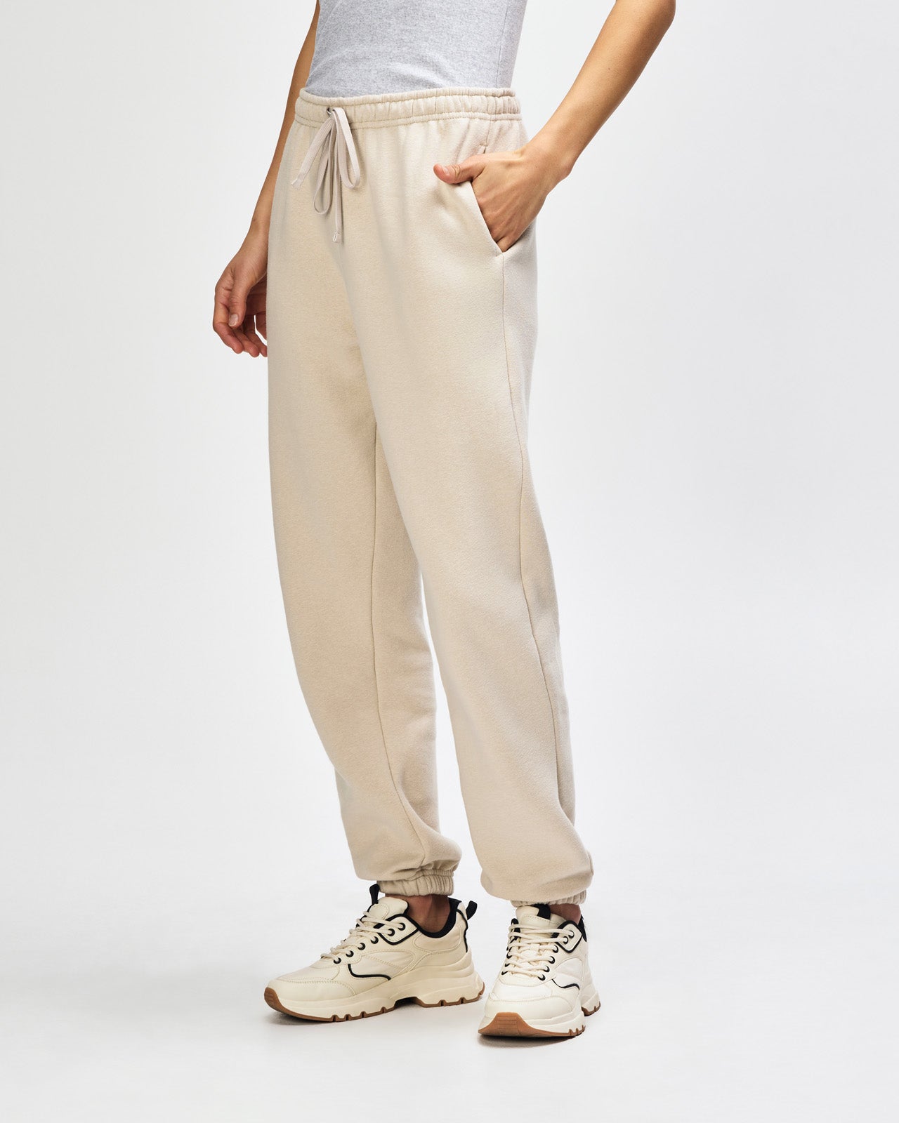 Female model wearing American Apparel Sweatpants (front pose) -bone