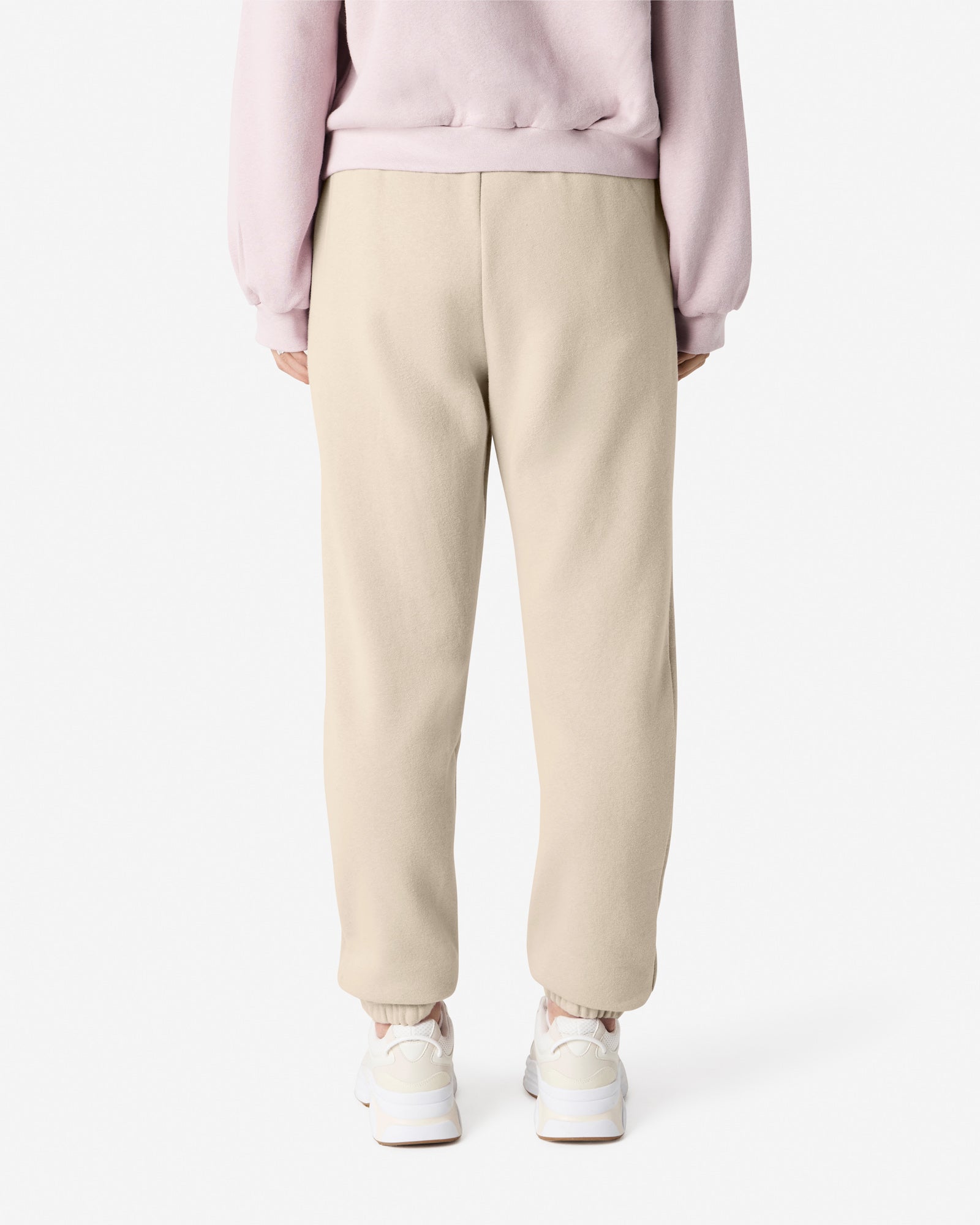 Female model wearing American Apparel Bone Sweatpants (back pose) -bone