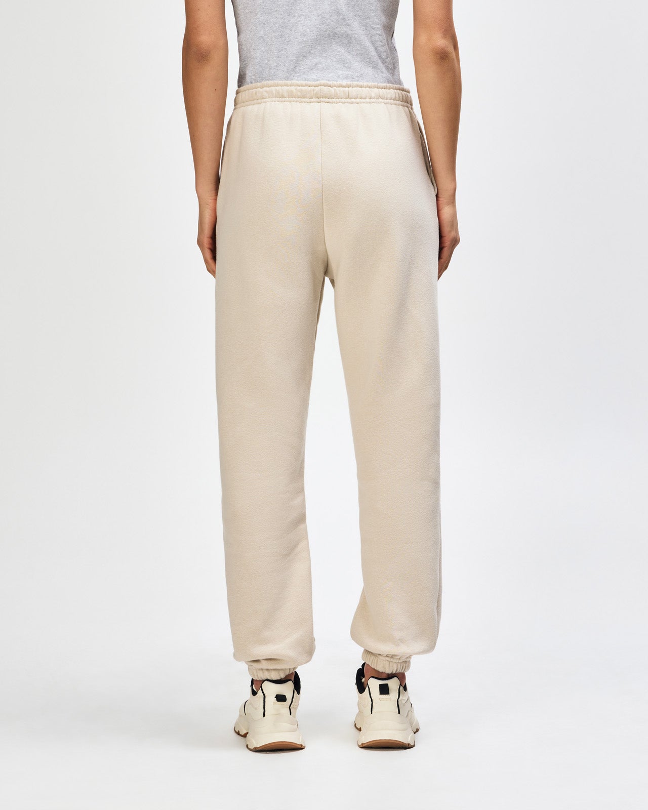 Female model wearing American Apparel Sweatpants (back pose) -bone