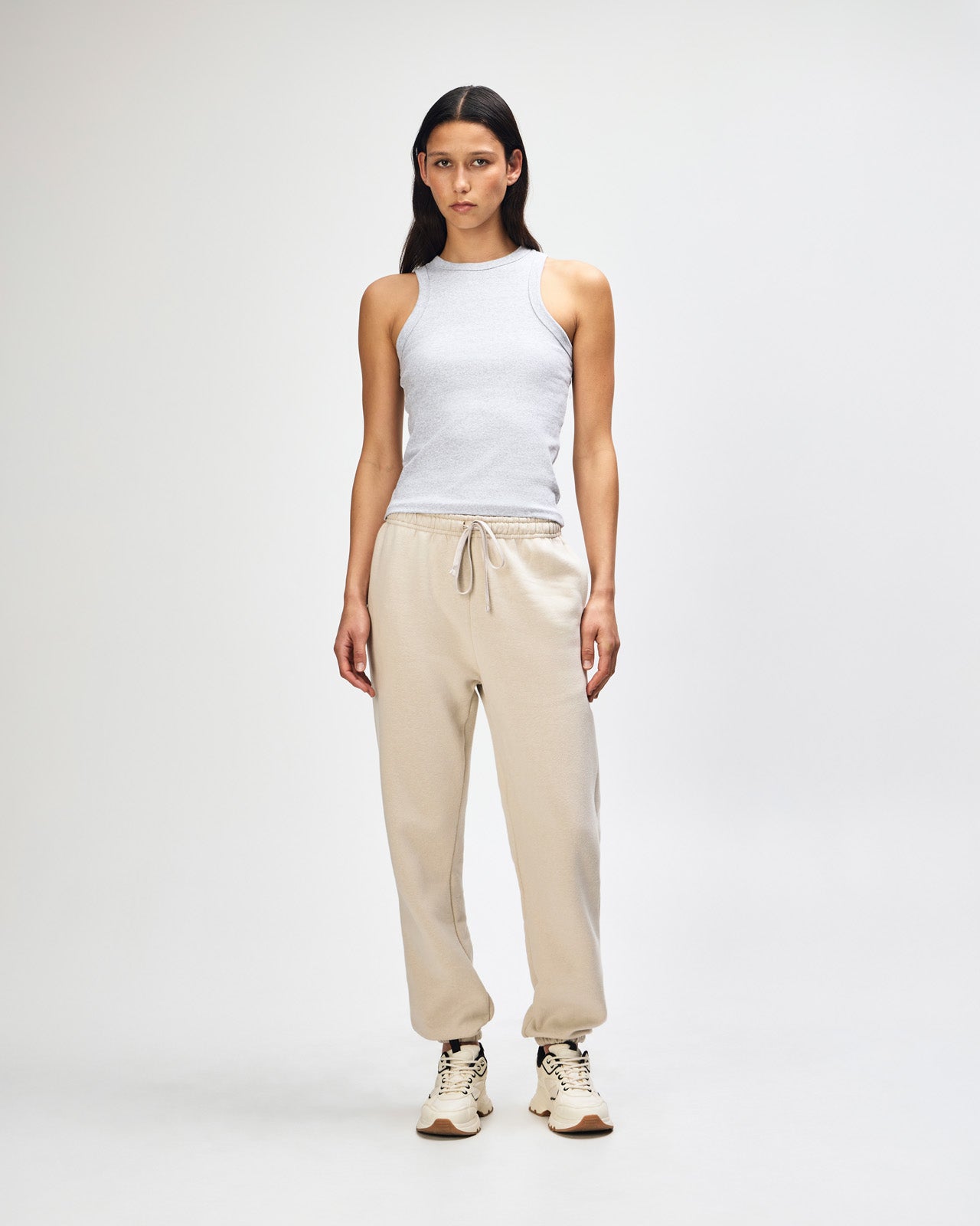 Female model wearing American Apparel Sweatpants (front pose) -bone