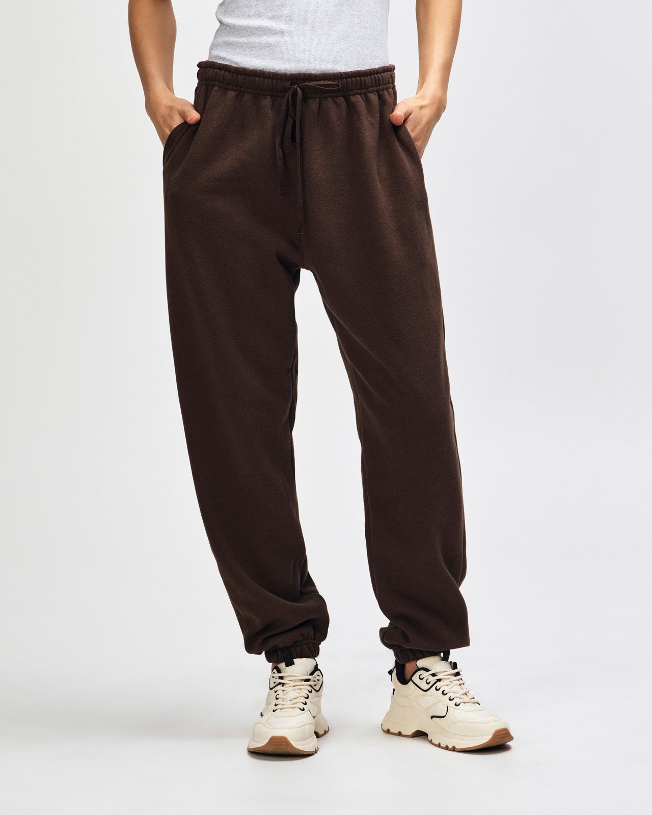 Female model wearing American Apparel Sweatpants (front pose) -brown