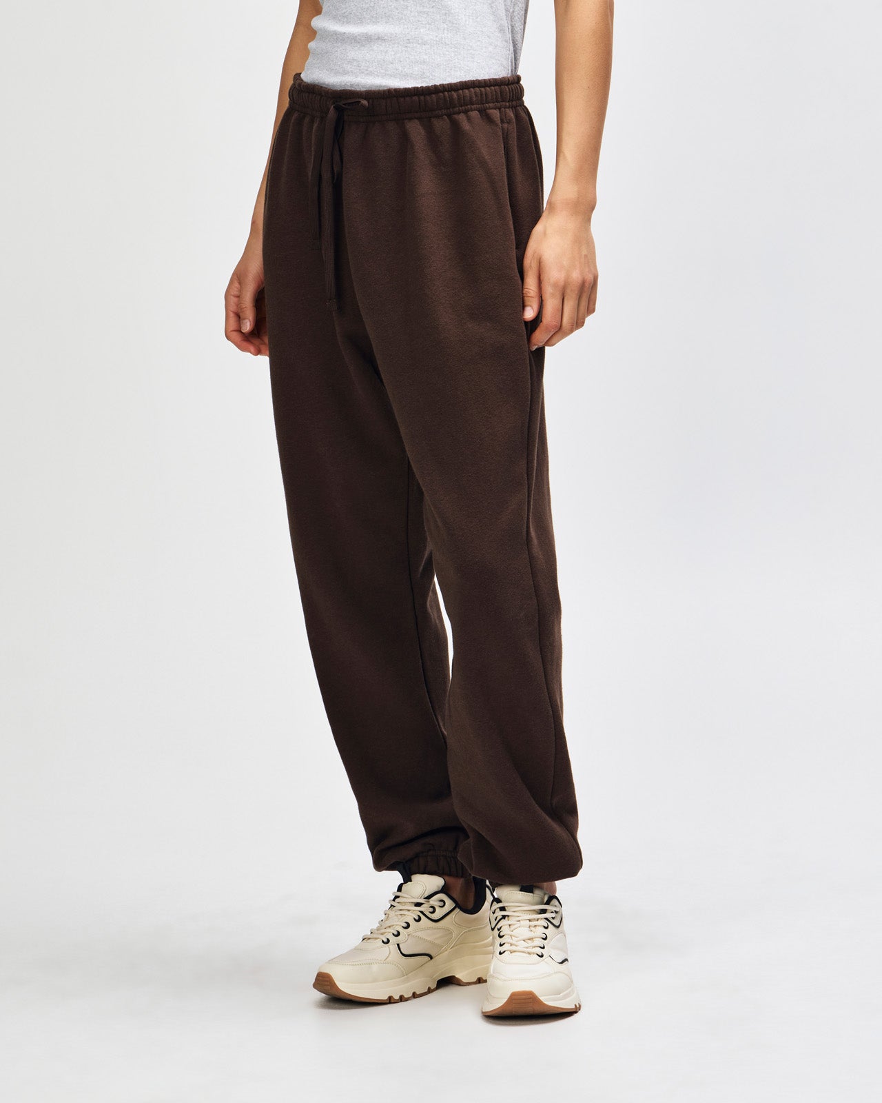 Female model wearing American Apparel Sweatpants (front pose) -brown