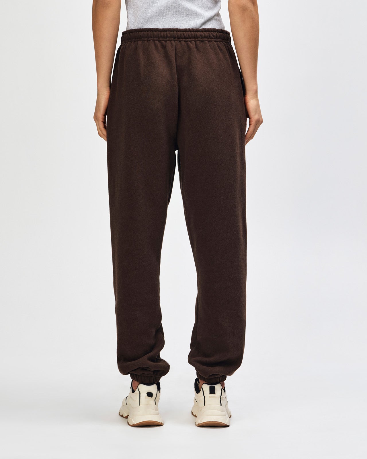 Female model wearing American Apparel Sweatpants (back pose) -brown