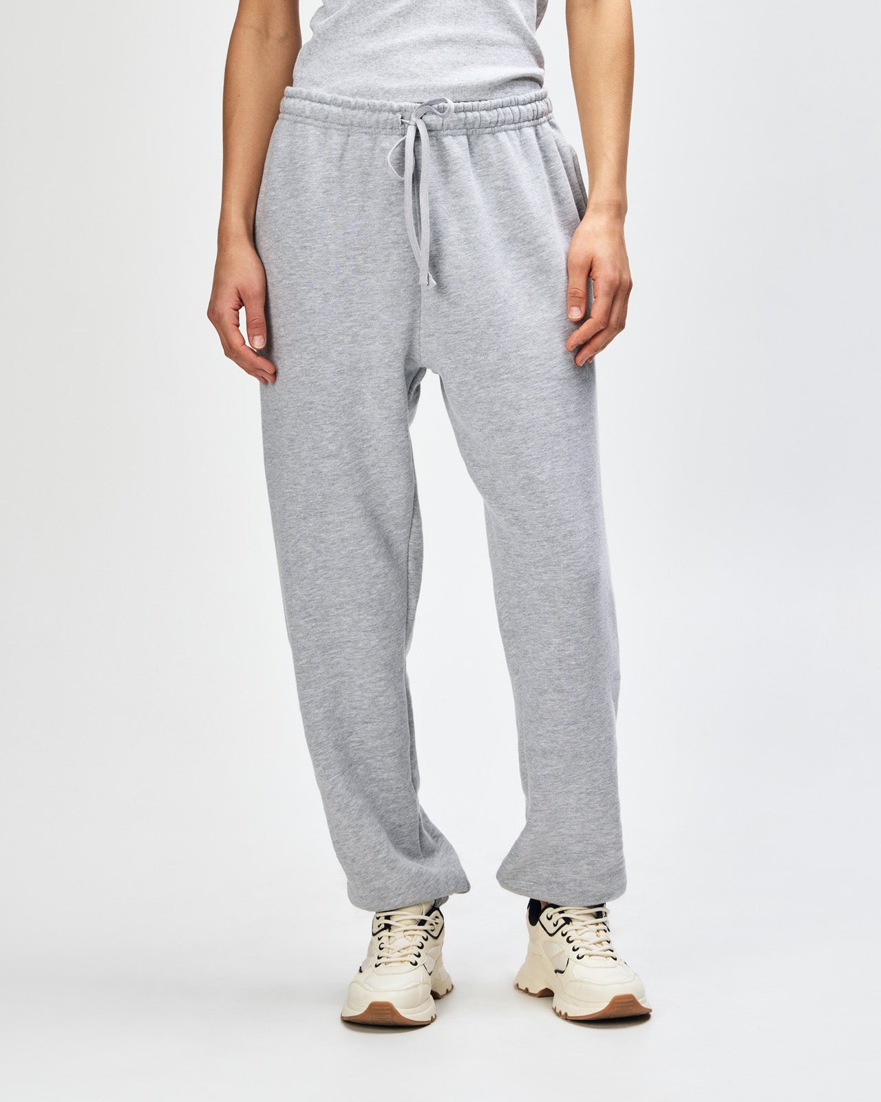 Female model wearing American Apparel Sweatpants (front pose) -heather grey