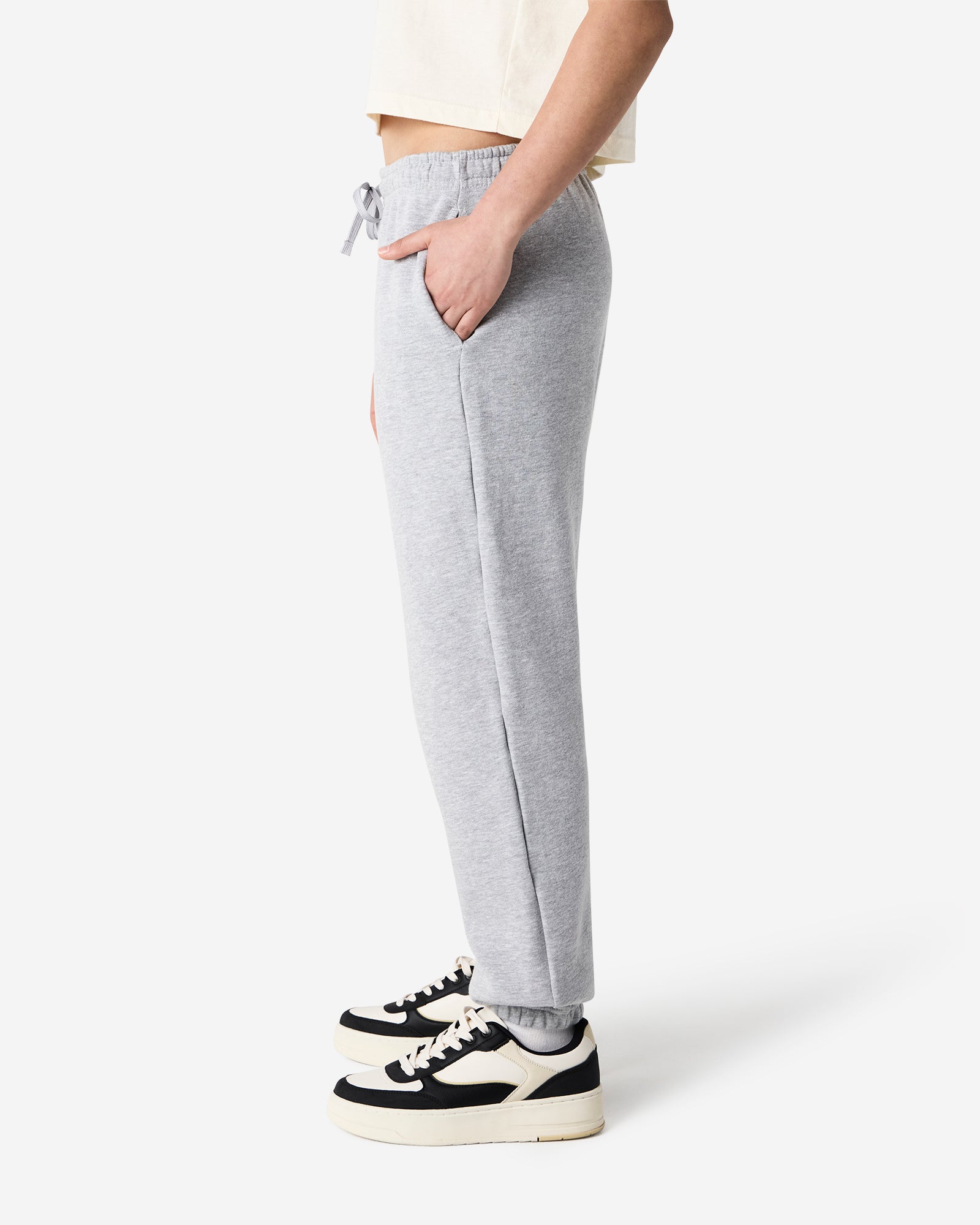 Female model wearing American Apparel Heather Grey Sweatpants (side pose) -heather grey