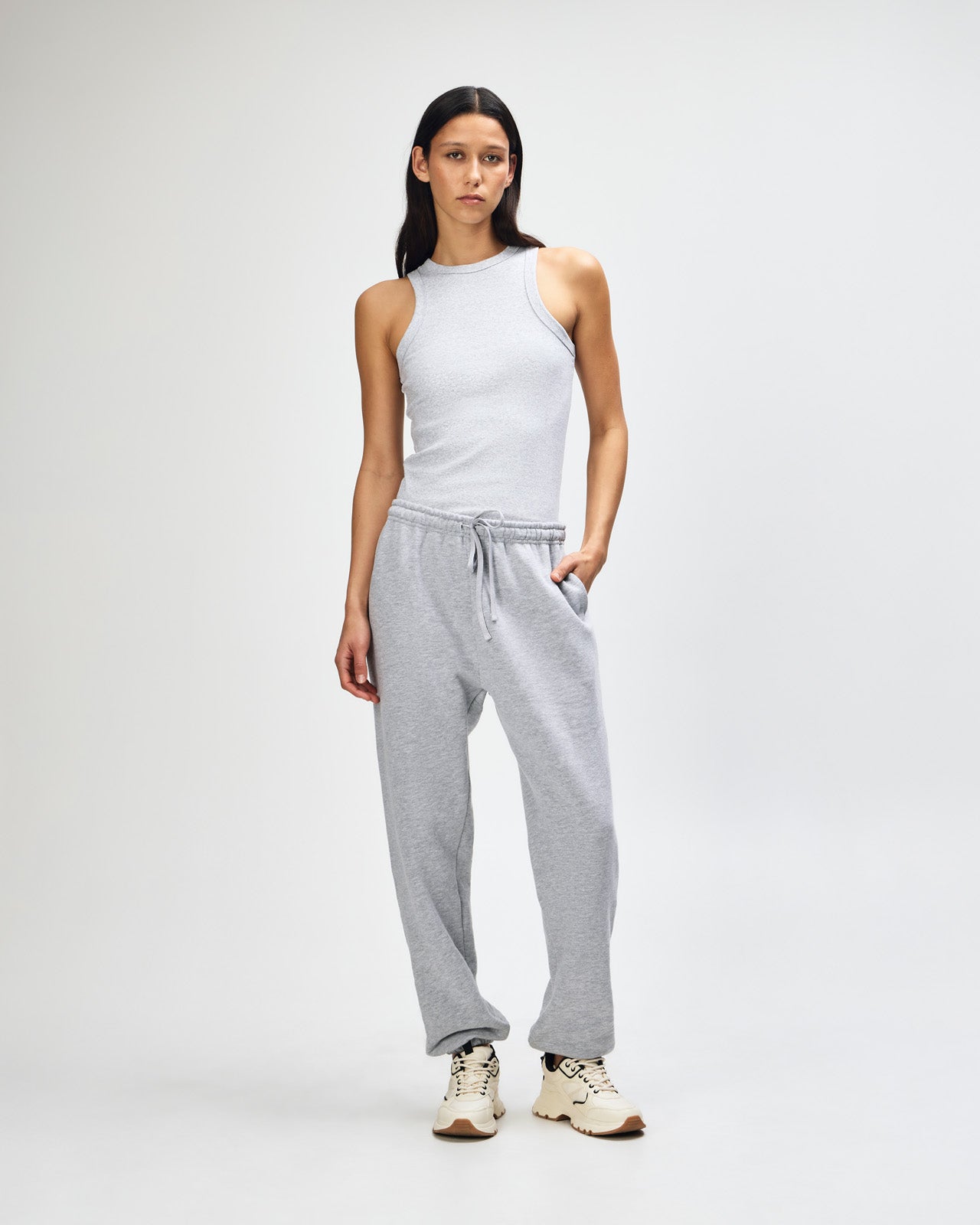 Female model wearing American Apparel Sweatpants (front pose) -heather grey