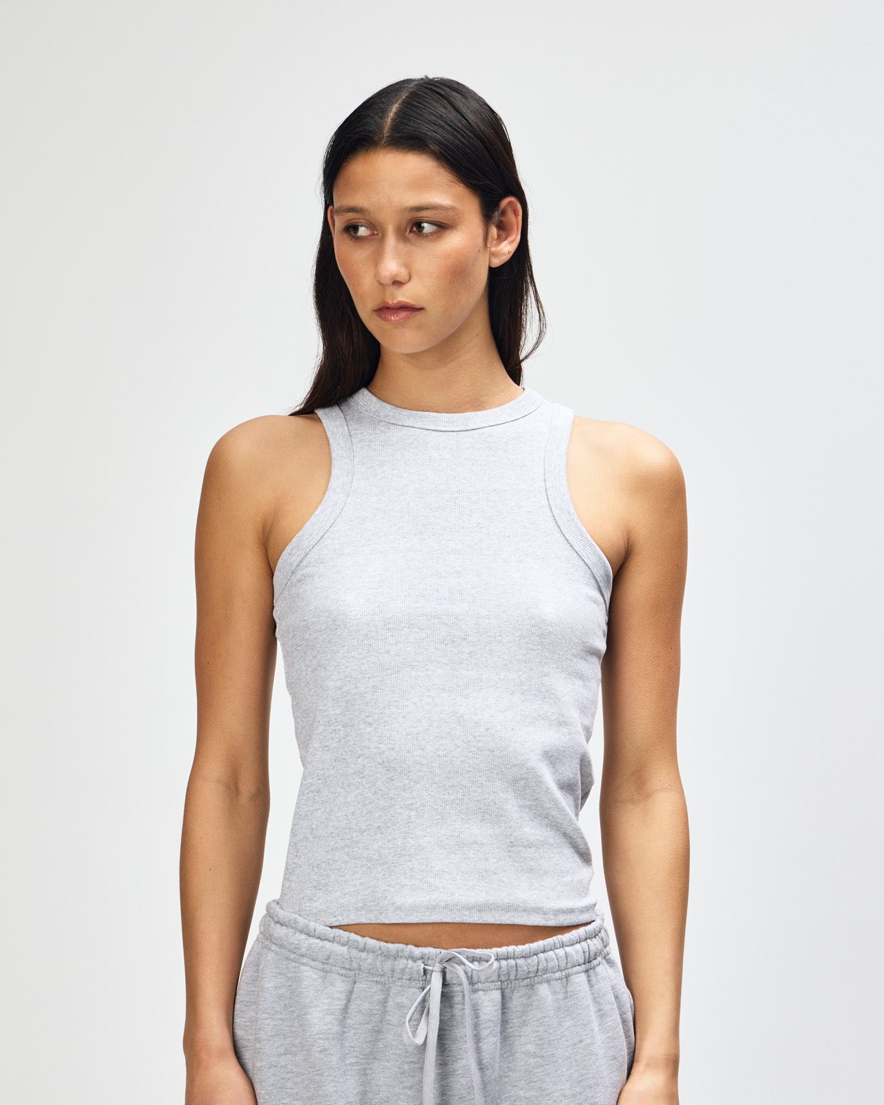 Female model wearing American Apparel Sweatpants (front pose) -heather grey