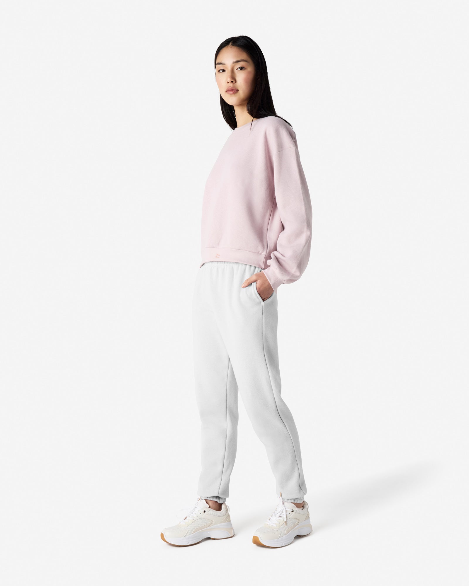 Female model wearing American Apparel White Sweatpants (front pose) -white