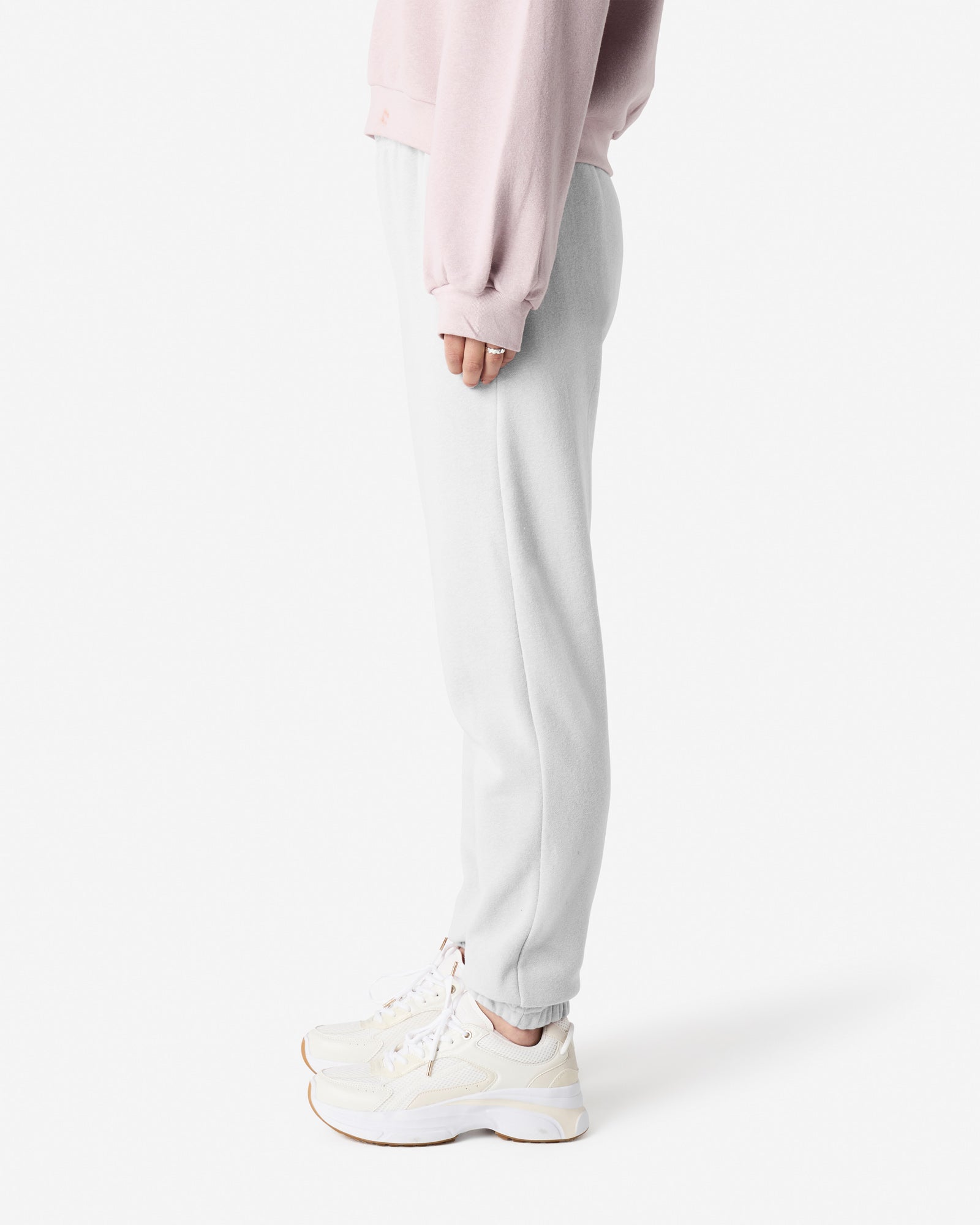 Female model wearing American Apparel White Sweatpants (side pose) -white