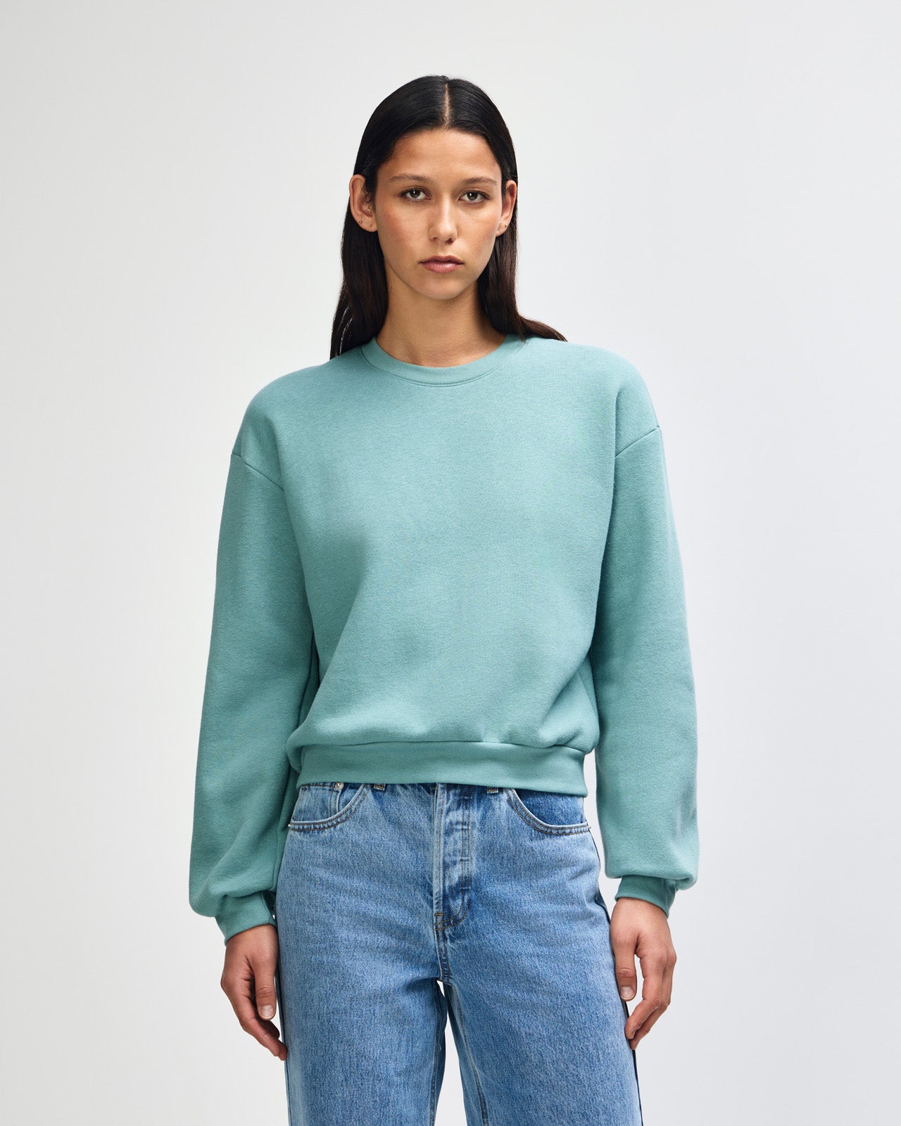 Model wearing an arctic colour sweatshirt pairing with blue jeans (front pose) -arctic